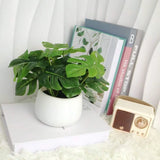 artificial monstera plant in white planter